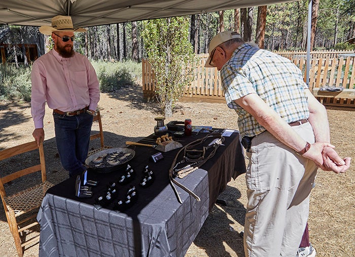 Pat Horlacher shows the traditional silversmithing that he produces for working cowboys.