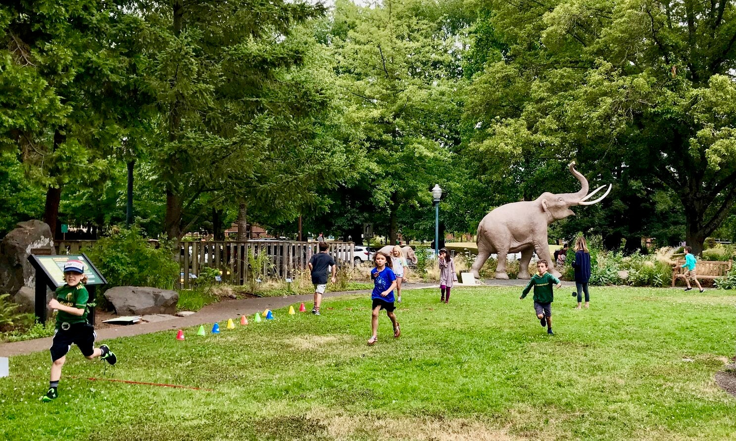 six children running around the museum courtyard