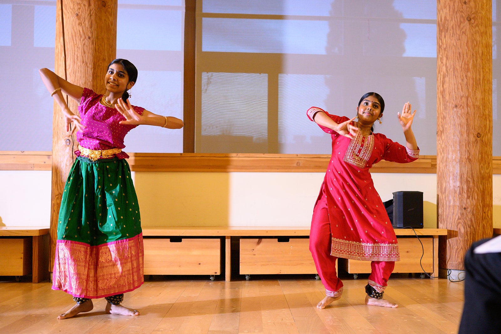 Two young women dancing in saris