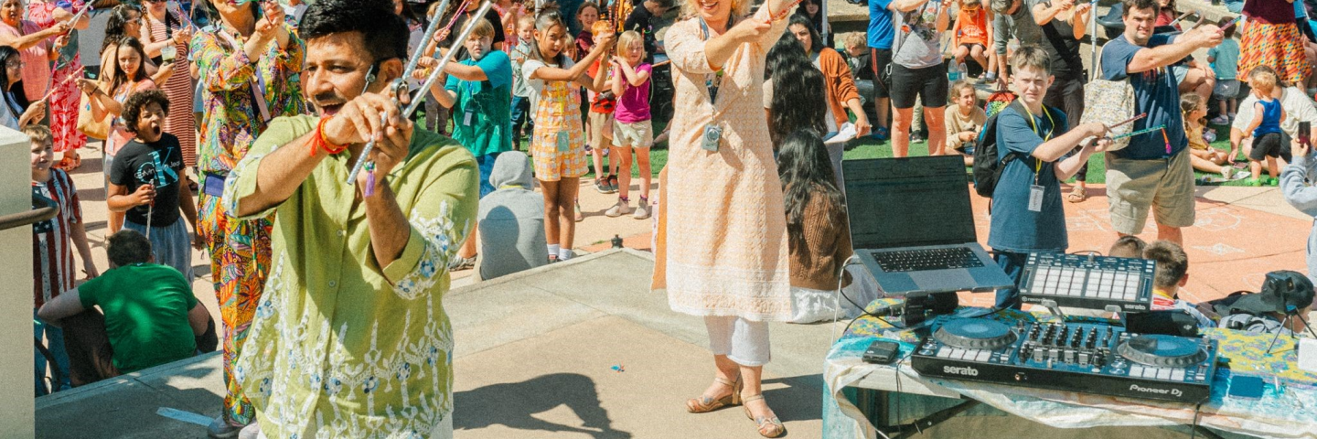 people outside with a musician