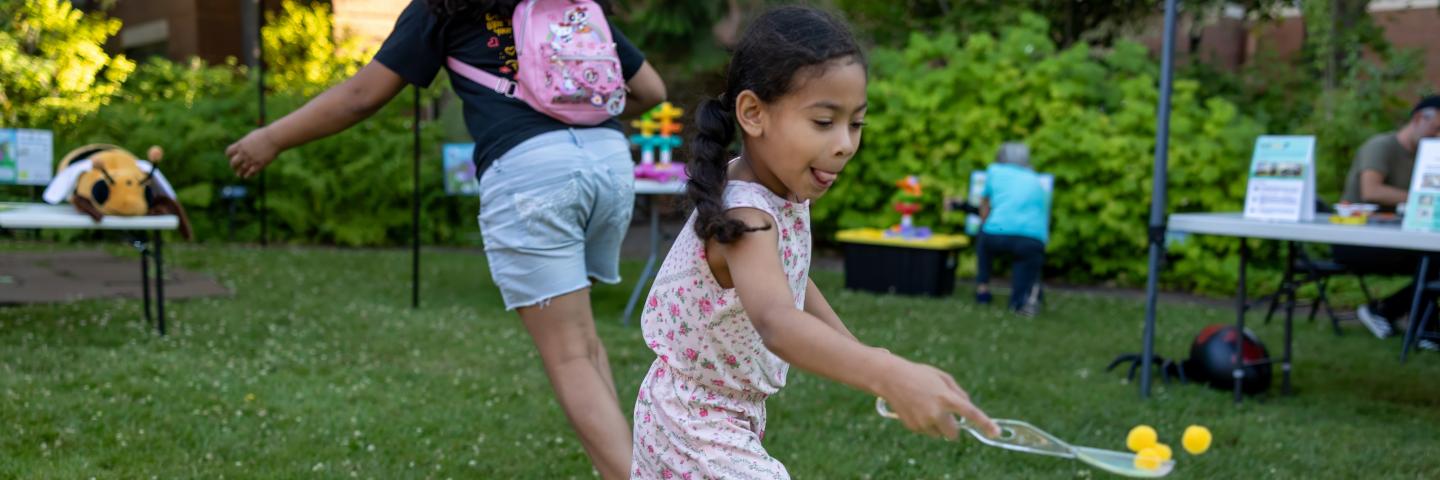 Young girl runs to do a science activity outside
