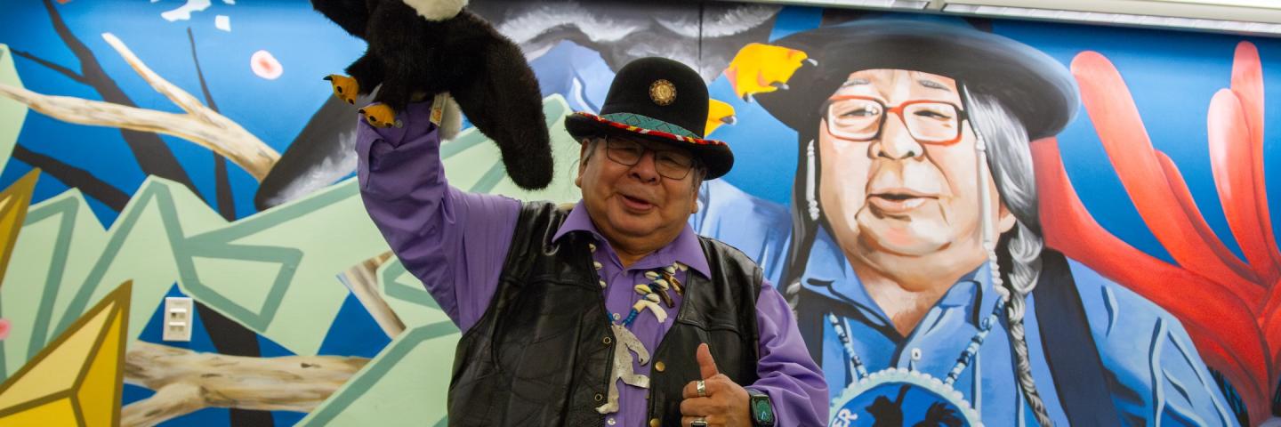 Ed in front of a mural of himself