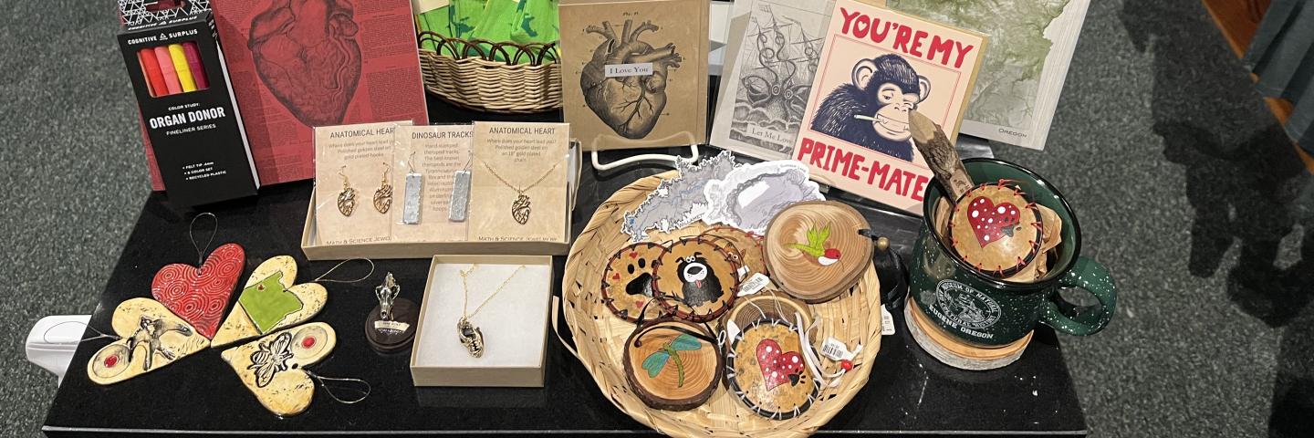 A table full of pink, red, and science-themed goods