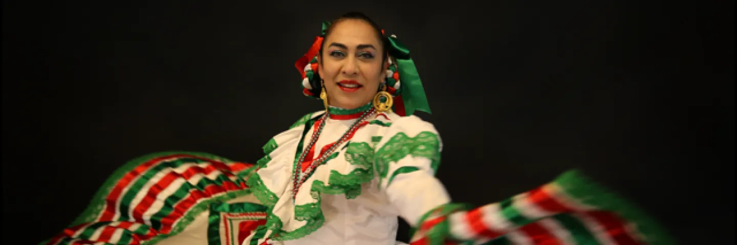 Woman dancing in traditional Mexican dress