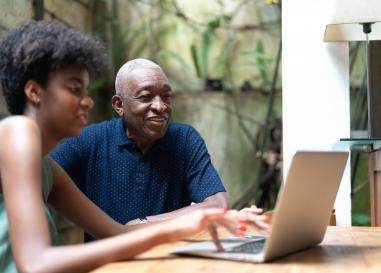 Two people share a computer