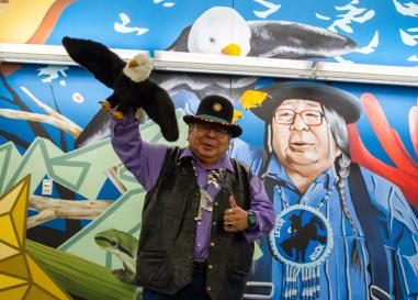 Ed in front of a mural of himself