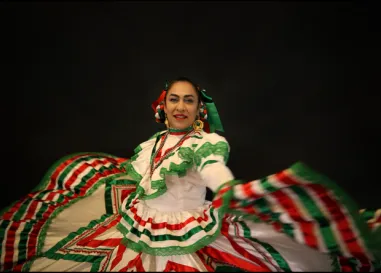 Woman dancing in traditional Mexican dress