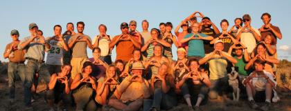 Group of field school students throwing the &quot;O&quot; hand sign