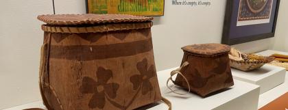 Two brown birchbark boxes, one with flowers and one with ducks