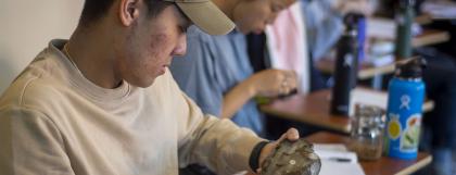 Student examining a pinniped fossil from the museum's collections