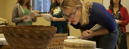 UO students examine a Native American basketry collection
