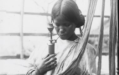 Woman with skein of dyed yarn and traditional water pipe