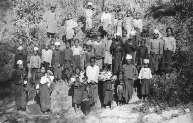 Chin men and women assembled at a pond