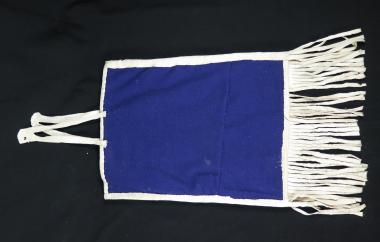 Backside of beaded bag. Solid blue beading with fringe.