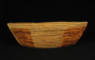 A woven basket of Juncus sp., sumac, deer grass.