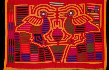 Mola with two birds standing over a flower in a pot. (exterior)