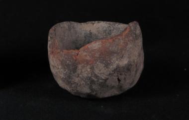 Small ceramic crucible, lamp, or mold with a burned exterior