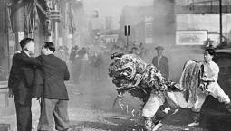 lion dancers on the street in black and white